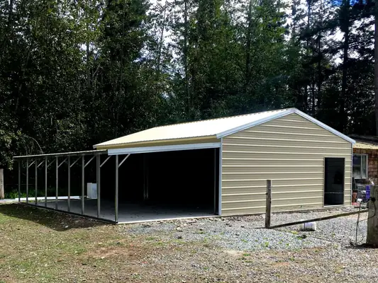 Enclosed garage with side lean-to carport
