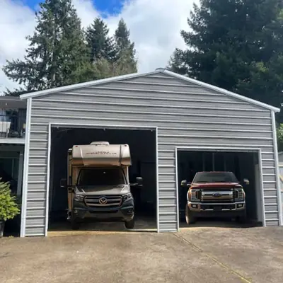Two-bay garage with RV and truck parked inside