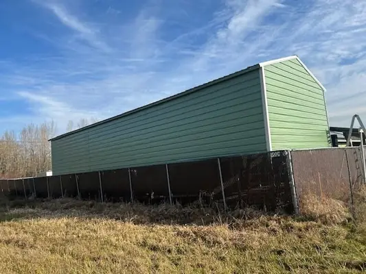 Long green A-frame metal building