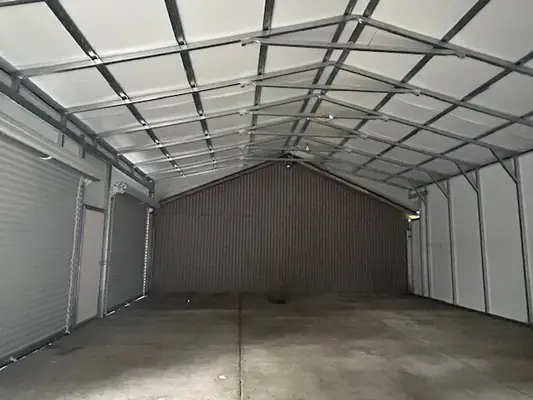 Inside an enclosed metal carport
