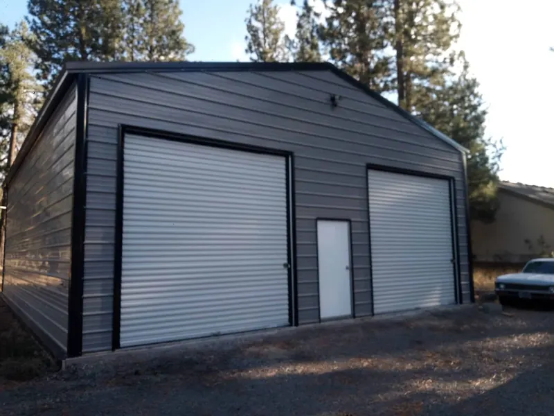 30x40 enclosed metal building with two roll-up doors installed by Skyliner Buildings