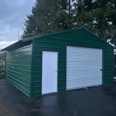 Green enclosed garage with roll-up door and walk-in door